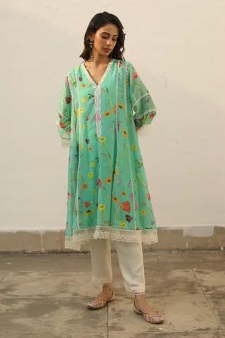 Turquoise A-line flared kurta with all over floral print crafted in chanderi. Comes along with a slip and pant.
Component: 3
Pattern: Printed
Type Of Work: Watercolor Floral Print
Neckline: V-neck
Sleeve Type: Sheer
Fabric: Kurta: Chanderi, Pant: Modal Cotton, Slip: Cotton
Color: Green
Other Details: 
Lace inserts detailing
Approx Kurta Length: 42 inches
Approx Pant Length: 38 inches
Occasion: Mehendi and Haldi - Aza Fashions Pakistani Cotton Suits, Cotton Suit Designs, Simple Kurtis, Fashion Quotes Inspirational, Lace Suit, Embroidery Fashion Detail, Embroidered Kurti, Watercolor Floral Print, Cotton Slip