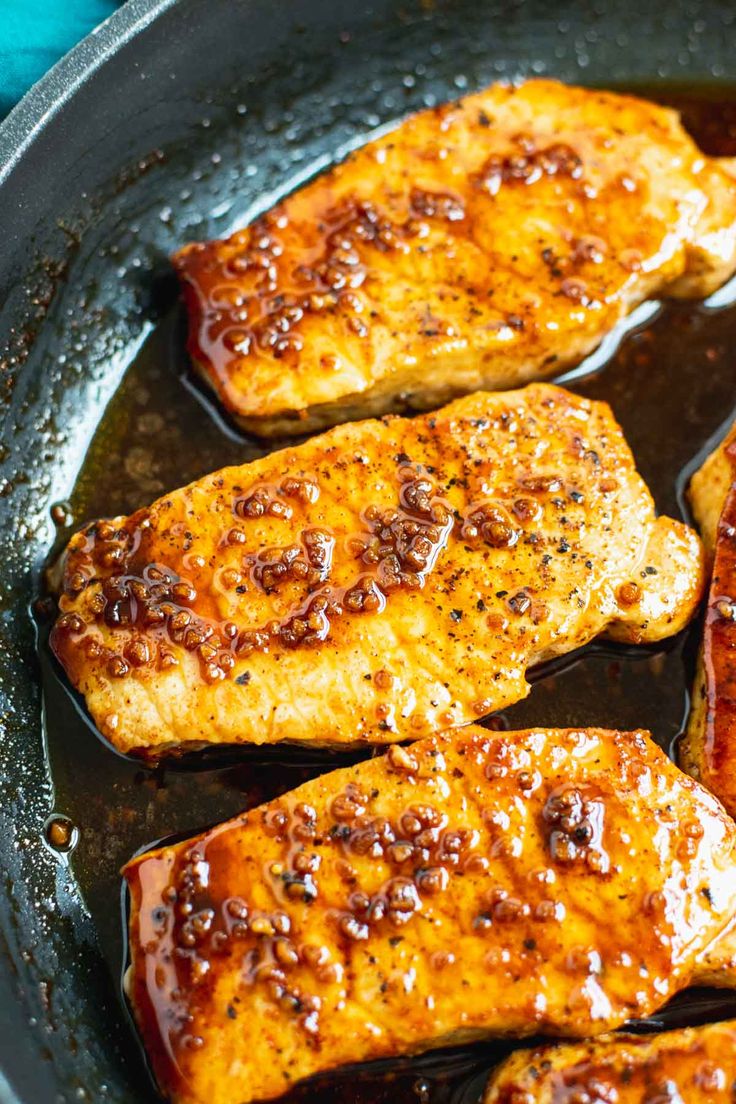 grilled pork chops in a skillet with text overlay that reads, nashville hot honey glazed pork chops