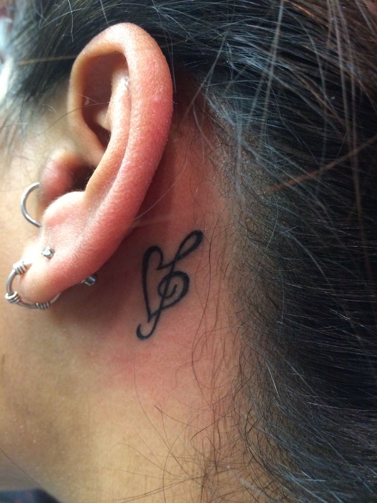 a woman's ear with a musical note behind the ear