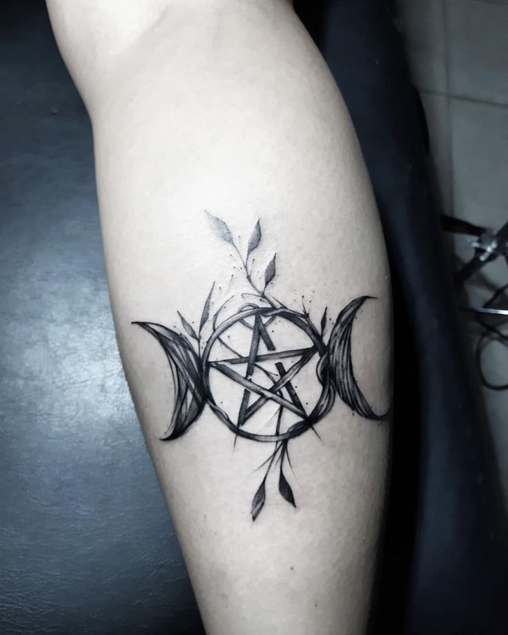 a black and white photo of a tattoo on the leg