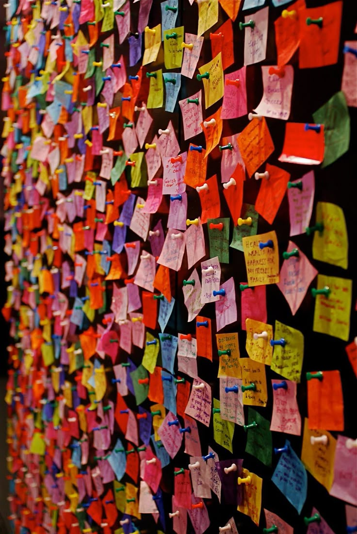 a wall covered in lots of colorful sticky notes