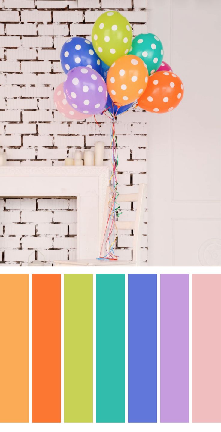 a bunch of colorful balloons are in front of a brick wall with white polka dots