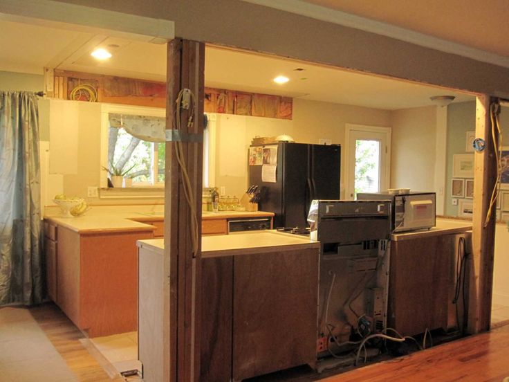 an open kitchen and living room with wood flooring in the foreground, looking into the dining area