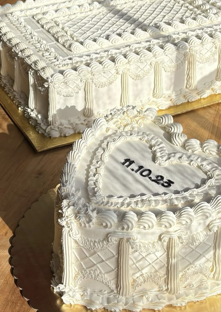 two heart shaped cakes sitting on top of a wooden table