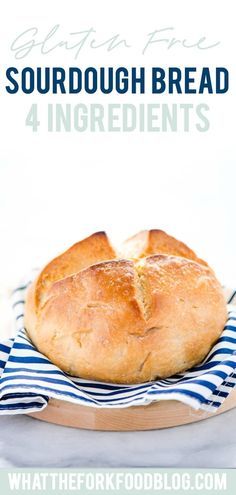 a loaf of sourdough bread sitting on top of a blue and white towel