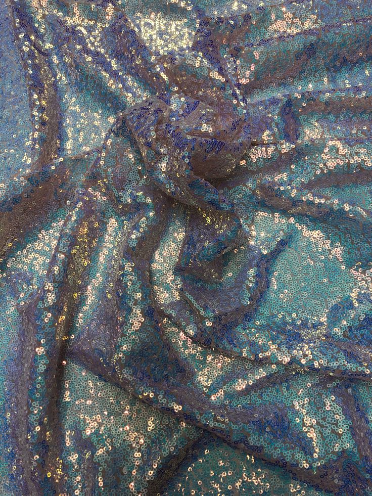 Image may look different due to setting on computer screen!The all over sequins fabric has sequins all over the fabric with nylon mesh backing. The sequins has an iridescent effect, which illuminates different colors at different angles. The fabric has a slight 4 way stretch on it, which makes it easy to work with. Fabric is sold by the yard. If more than one yard is purchased, item will come in one piece. Content: 100% Polyester Uses: Costumes, Gowns, Wedding Decor, Home Decor, Accessories, Bac Glamorous Iridescent Sequin Fabric For Party, Festive Blue Sequin Dress, Blue Sequin Dress For Festive Occasions, Glamorous Blue Sparkling Sequin Fabric, Glamorous Sparkling Blue Sequin Fabric, Blue Sequin Fabric For Party Season, Glamorous Blue Sequin Fabric For Festive Occasions, Glamorous Blue Sequin Fabric For Party Season, Blue Sparkling Sequin Fabric For Party