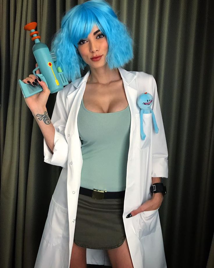 a woman with blue hair is holding a spray bottle and wearing a white lab coat