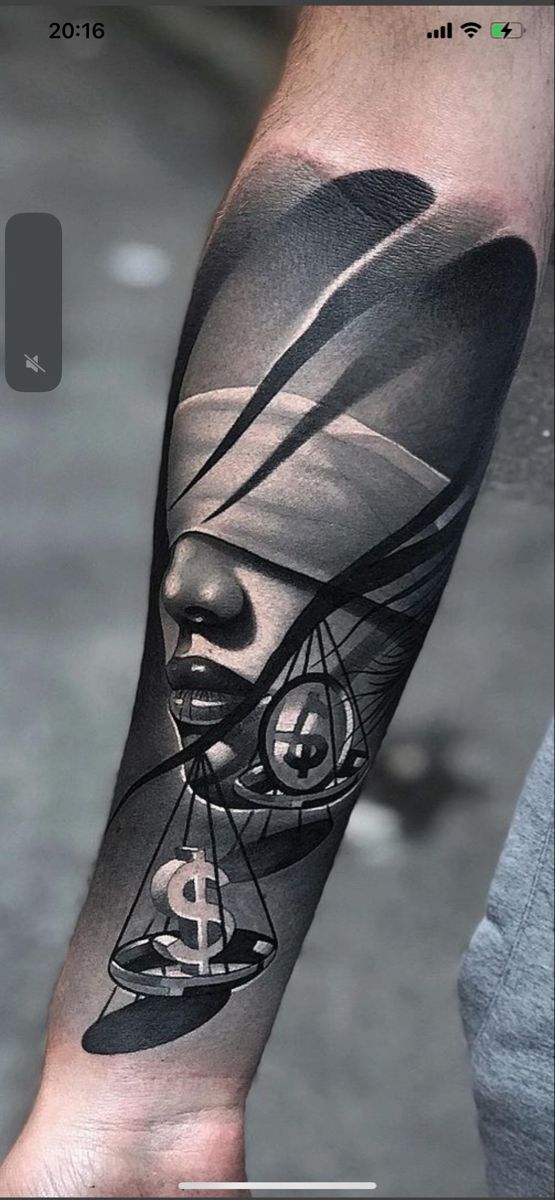 a man with a tattoo on his arm that has an image of a person holding a clock