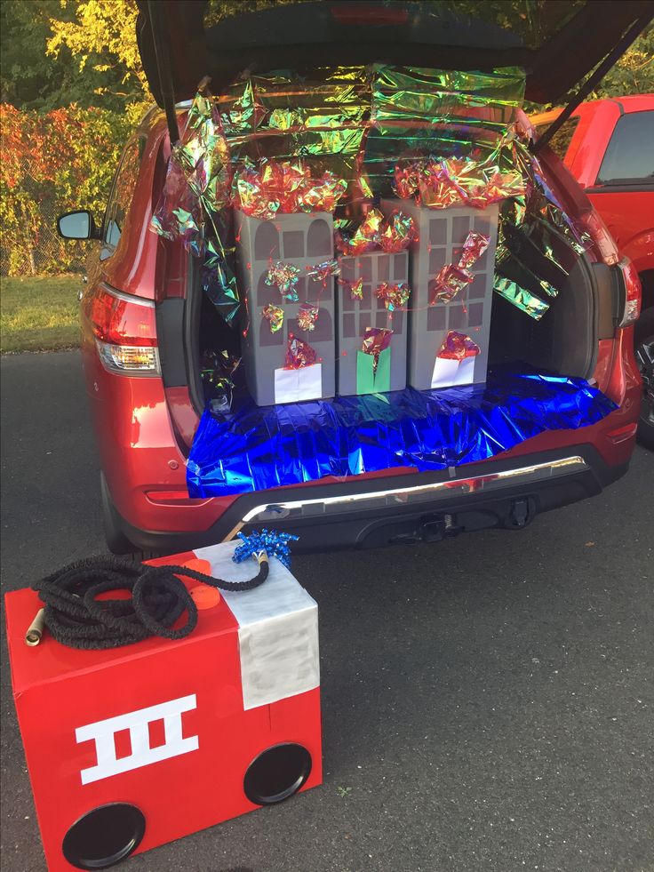 the back end of a red car with presents in it