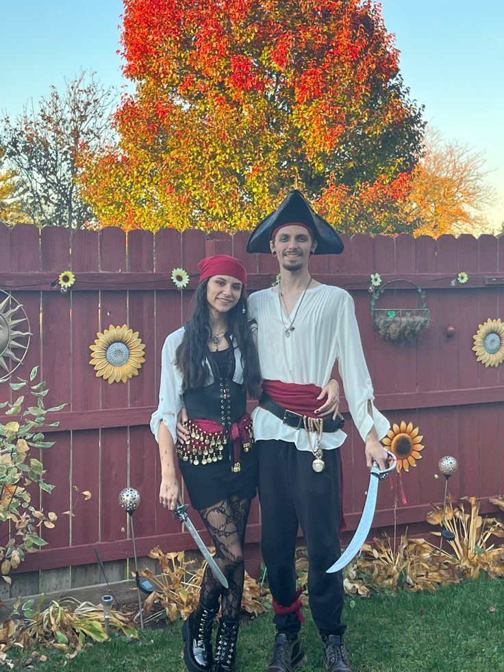 a man and woman dressed in pirate costumes