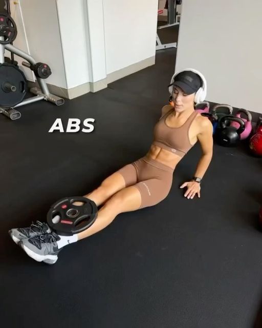 a woman is laying on the floor with headphones in her ears and looking at the camera