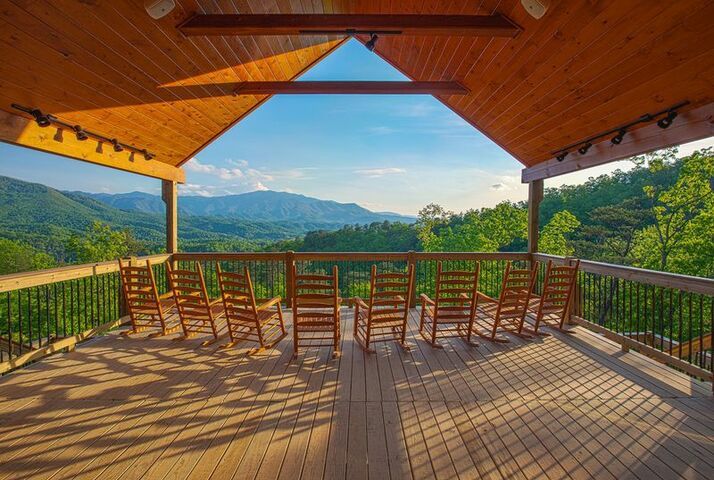 a wooden deck with chairs on it and the words kiss back and relax above them