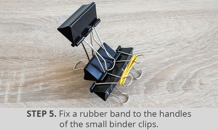 a group of small black and yellow binders sitting on top of a wooden table