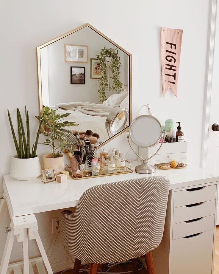 a white desk with a mirror on top of it and a chair in front of it