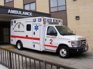 an ambulance is parked in front of a building with its doors open and the number 2 on it