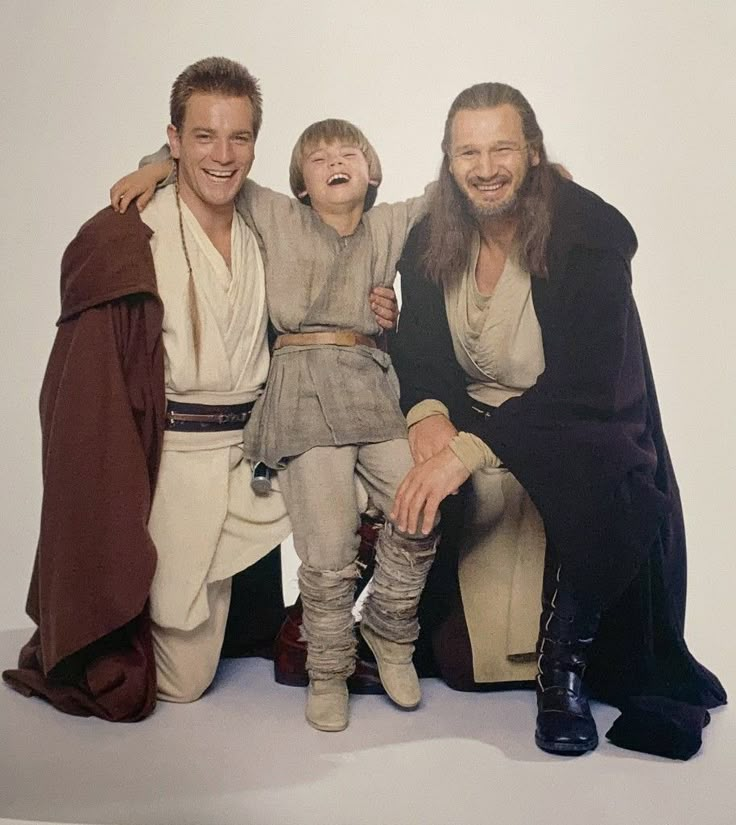 two men and a boy are posing for a photo with luke star wars costume on