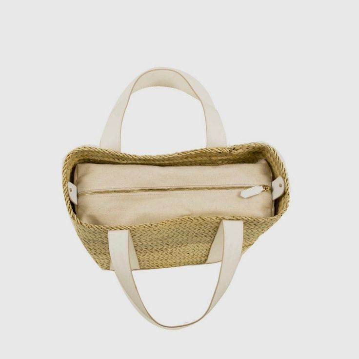 Handcrafted by women in Morocco, the Amira straw handbag boasts impeccable craftsmanship and high quality materials. This lightweight tote is the perfect summer accessory; its rustic touch makes it perfect for strolling at the beach and in the city. Woven from palm leaves, this basket is decorated with white vegan leather detail and comes with an interior zipped and removable canvas pouch. Handwoven in Morocco 100% natural woven palm leaf. Trim: 100% vegan leather Removable canvas pouch with top Straw Handbags, Leather Detail, Canvas Pouch, Palm Leaf, Summer Accessories, Palm Leaves, Perfect Summer, At The Beach, Summer Style