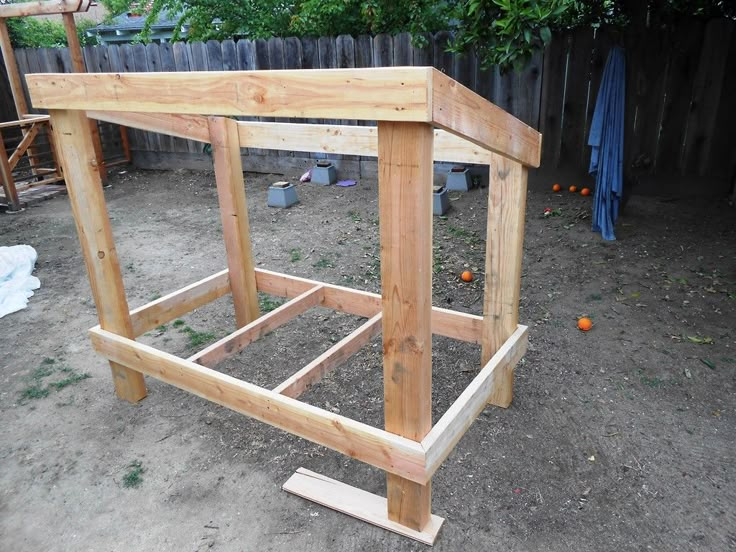 a wooden structure sitting in the middle of a yard