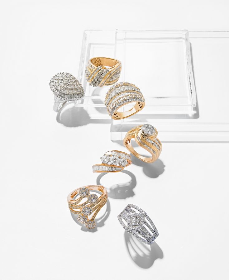 five different types of rings sitting on top of a white table next to each other