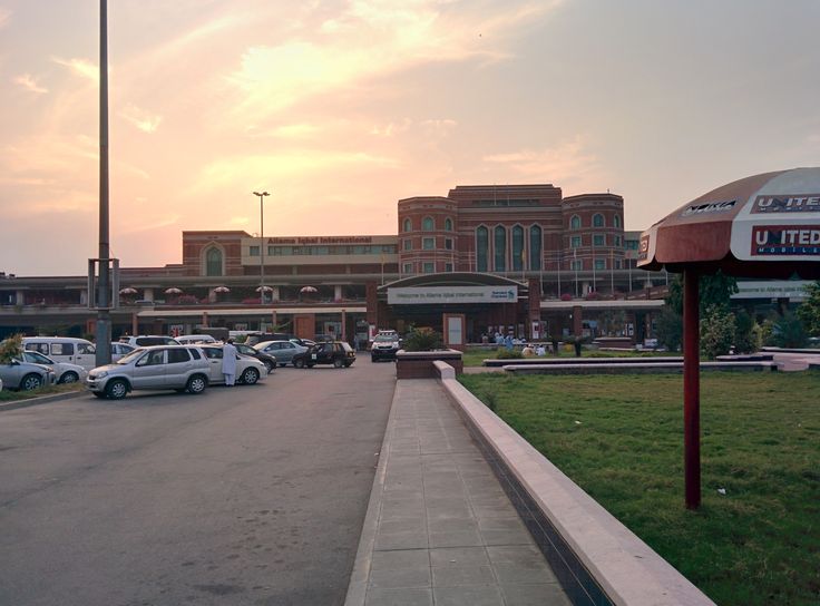 cars are parked in front of a large building