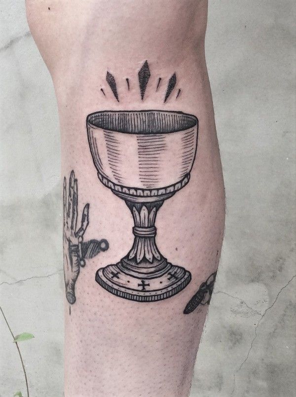 a tattoo on the leg of a person with a bowl and utensils in it