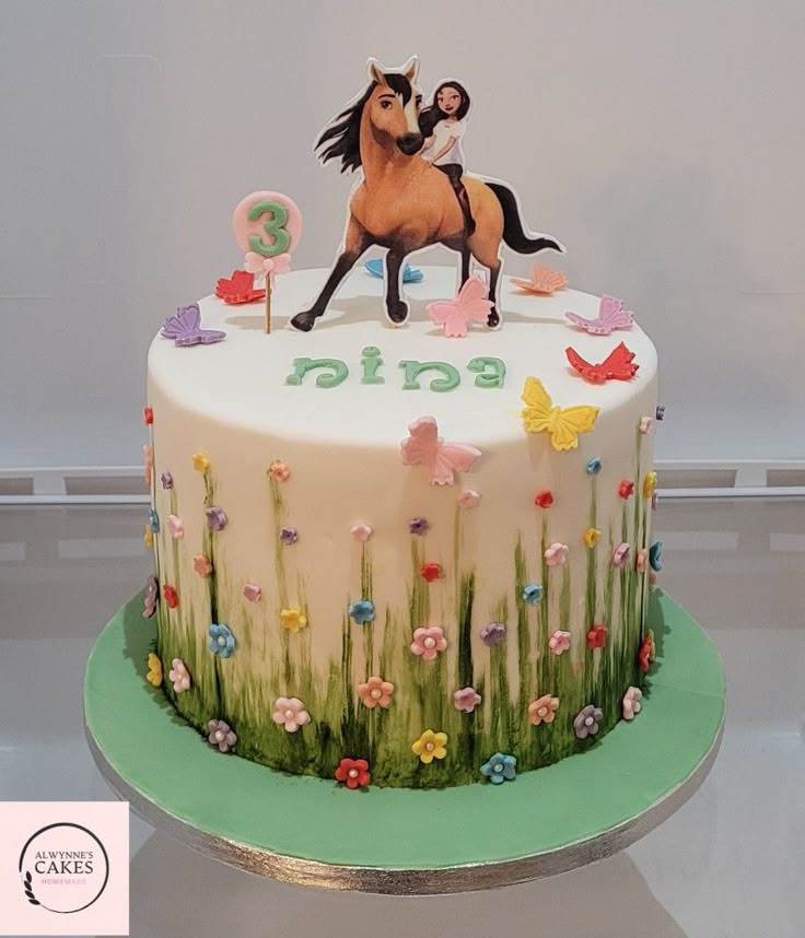 a birthday cake decorated with a horse and flowers