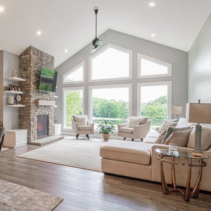 a living room filled with furniture and a fire place in the middle of a room