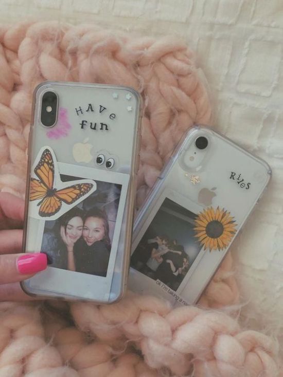 two cell phones sitting on top of a blanket next to each other, one with an image of a woman and the other with a sunflower