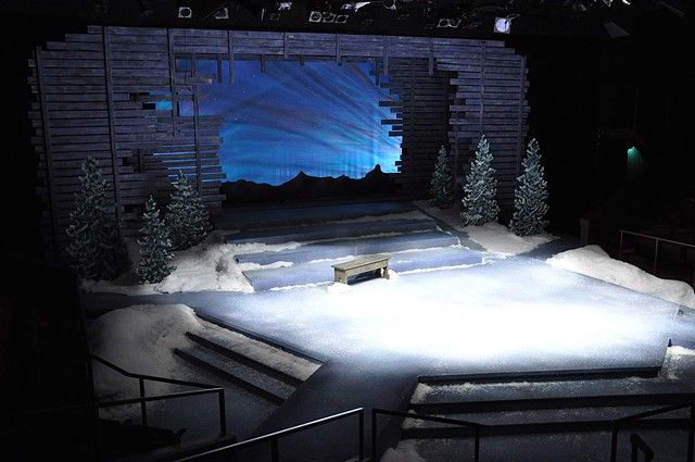 an empty stage with snow on the ground