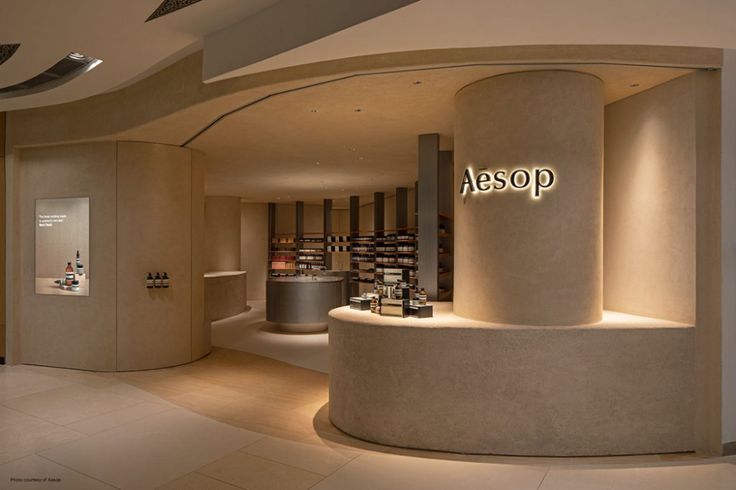 a store with a circular counter in front of it and an illuminated sign above the counter