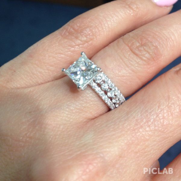 a woman's hand with a diamond ring on it