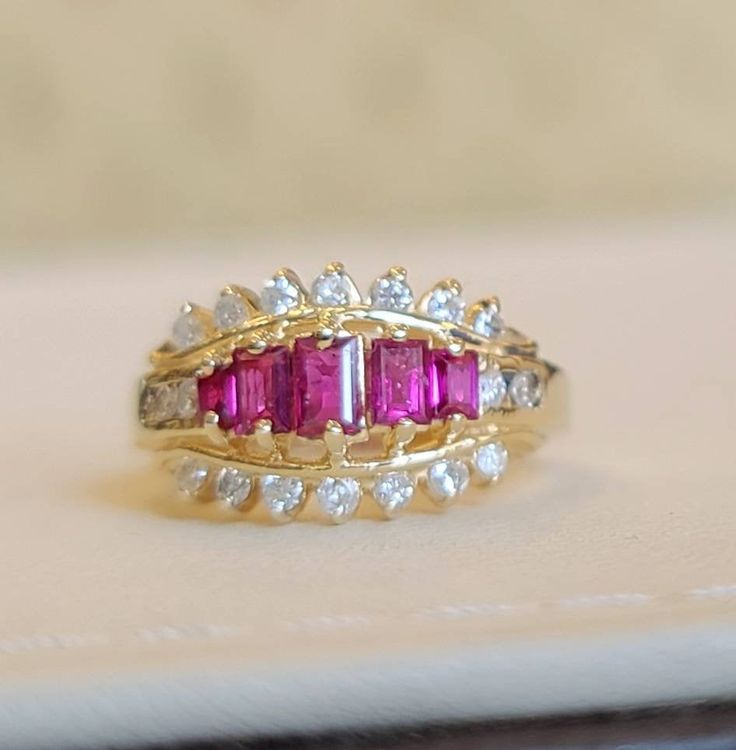 This is a 14kt yellow gold Ruby and diamond ring. Five pieces of straight baguette cut rubies total weight 0.89 carats. 18 pieces of small diamonds total weight 0.40 carats 14kt yellow gold ring weight 4.2 grams. Baguette Cut Ruby Yellow Gold Jewelry, Yellow Gold Ruby Baguette-cut Jewelry, Luxury Gold Ruby Ring With Single-cut Diamonds, Diamond And Ruby Ring, Vintage 14k Gold Multi-stone Ruby Ring, Luxury Multi-stone Ruby Ring In 14k Gold, Ruby And Diamond Ring, Butterfly Bracelet, Red Band