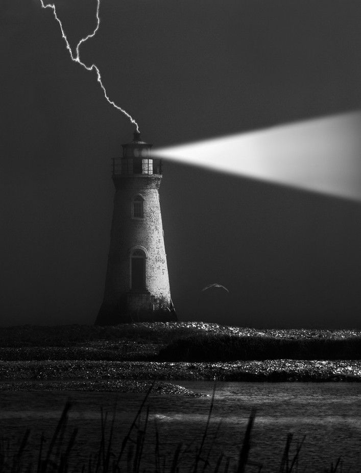 a black and white photo of a lighthouse with a lightening bolt in the background