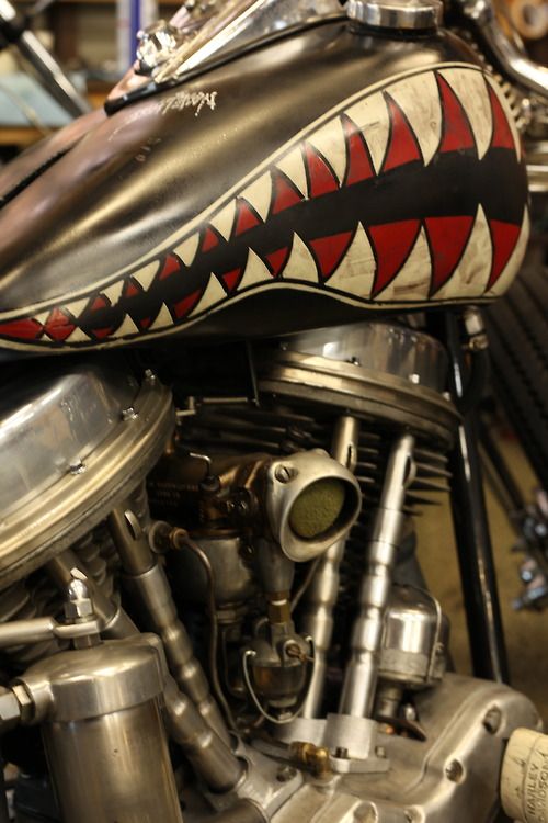 a close up of a motorcycle engine with red and black designs on it's side