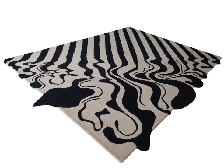 three black and white rugs on top of each other, one with an abstract design