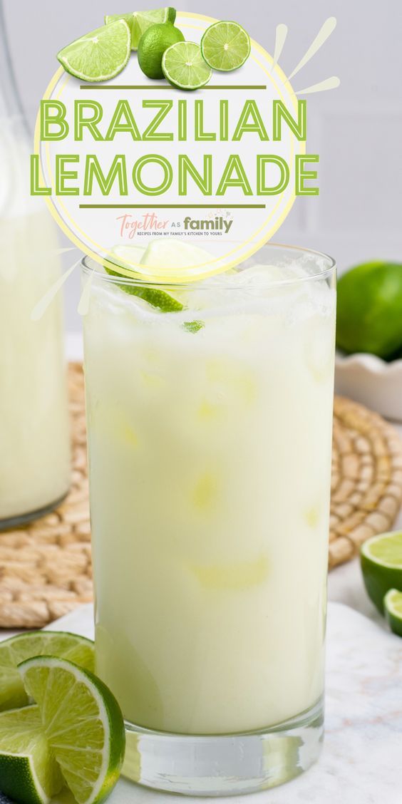 a close up of a drink in a glass with limes around it