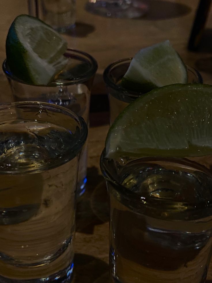 three glasses filled with water and lime slices