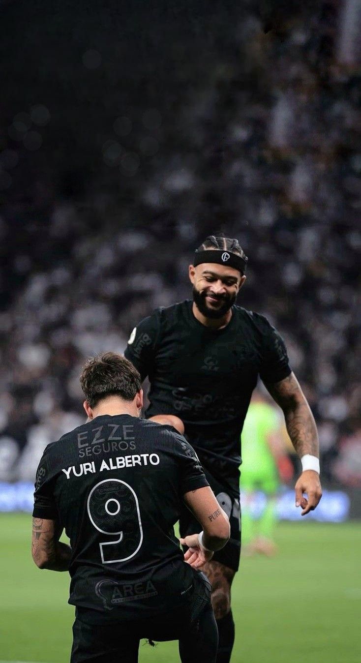 two men are playing soccer on the field