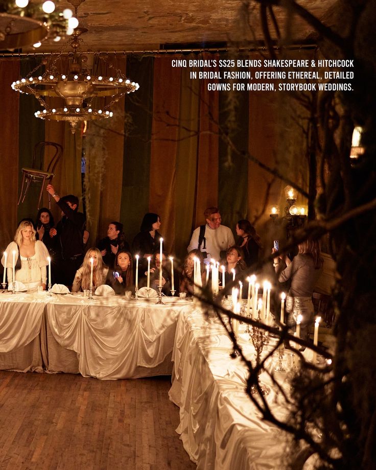 a group of people standing around a table with candles