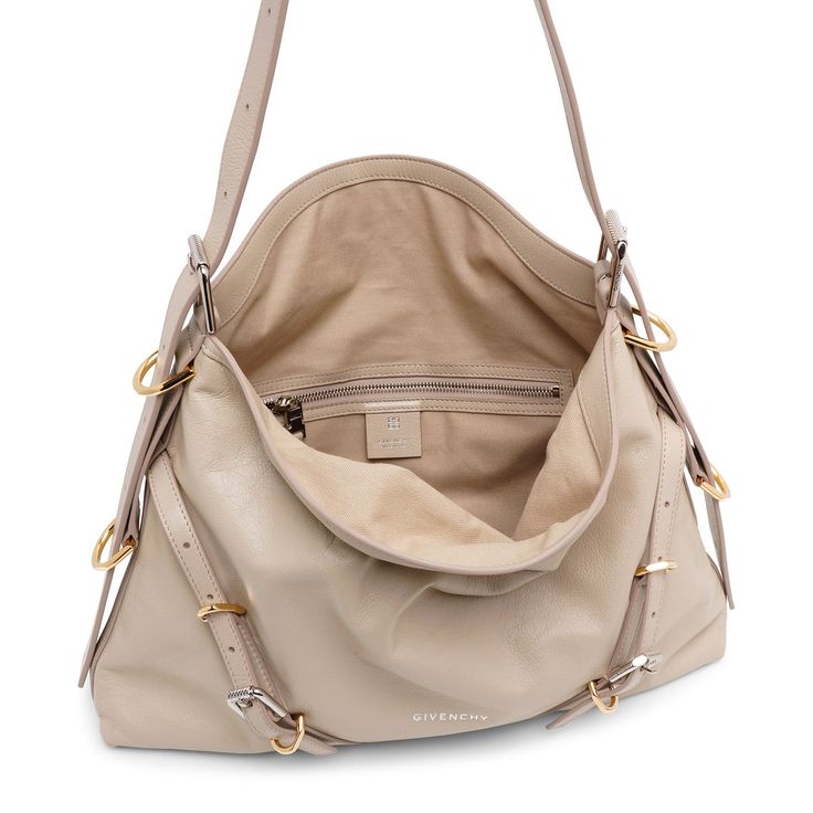 Beige leather shoulder bag from Givenchy. The Voyou medium shoulder bag is made of calf leather featuring both silver- and gold-toned hardware, an adjustable shoulder strap, complete with an internal pouch.Measurements: L40 x H27 x W6.5cmMade in Italy Beige Shoulder Bag, Leather Shoulder Bag, Calf Leather, Givenchy, Shoulder Strap, In Italy, Pouch, Shoulder Bag, Italy