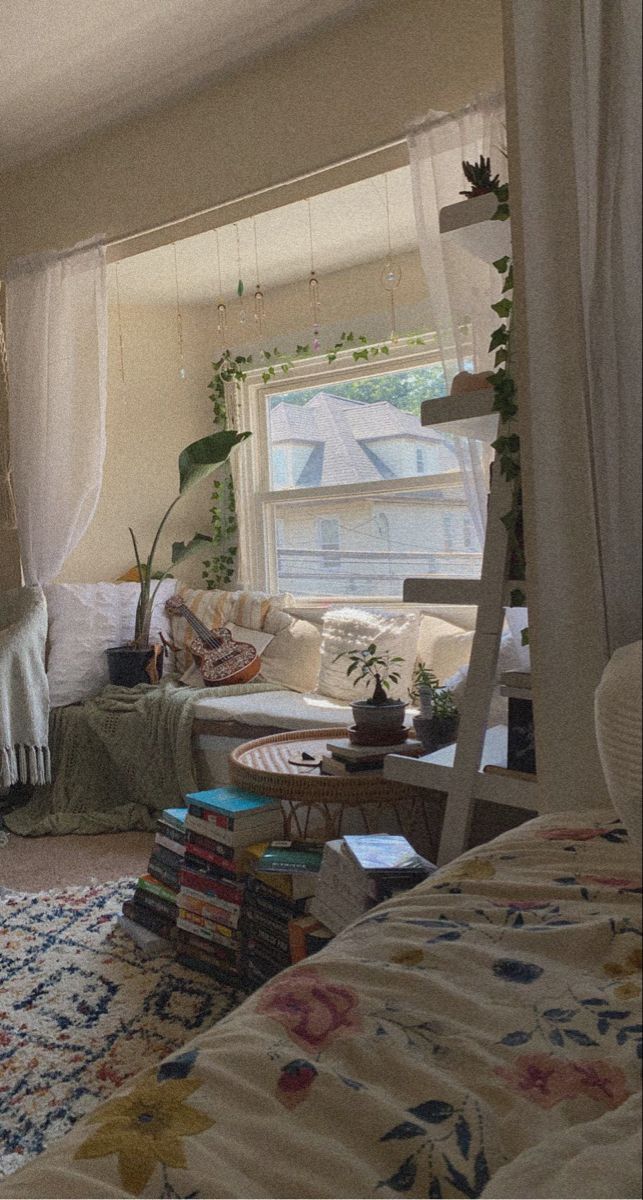 a living room filled with furniture next to a window covered in white drapes and curtains