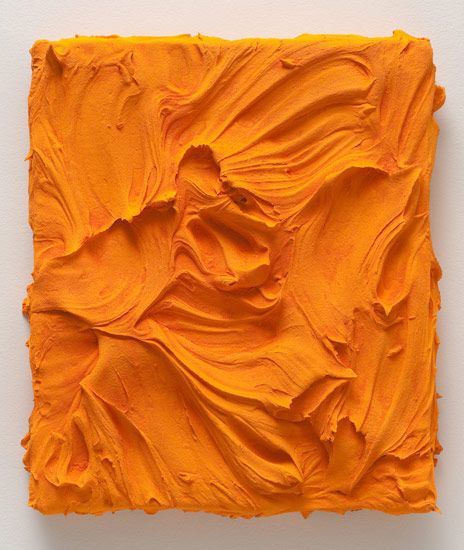 an orange piece of art that looks like it has been painted with acrylic paint