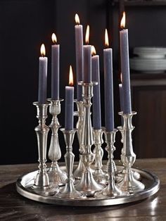 a silver candle holder with six candles on it