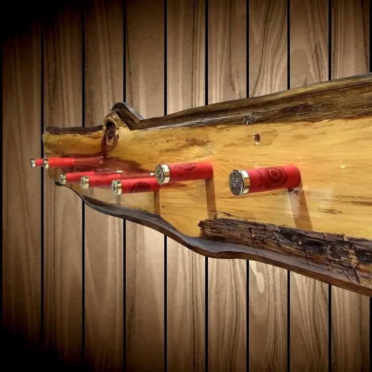 a piece of wood that has some red pipes attached to it and is hanging on the wall