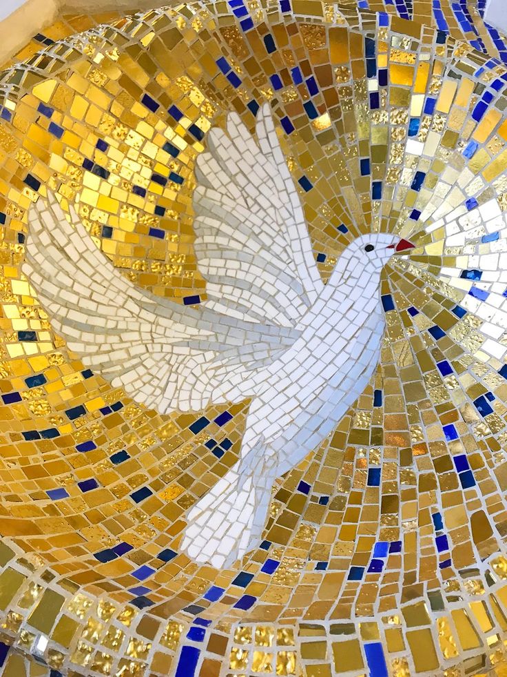 a white dove flying through the air on top of a yellow and blue mosaic tile