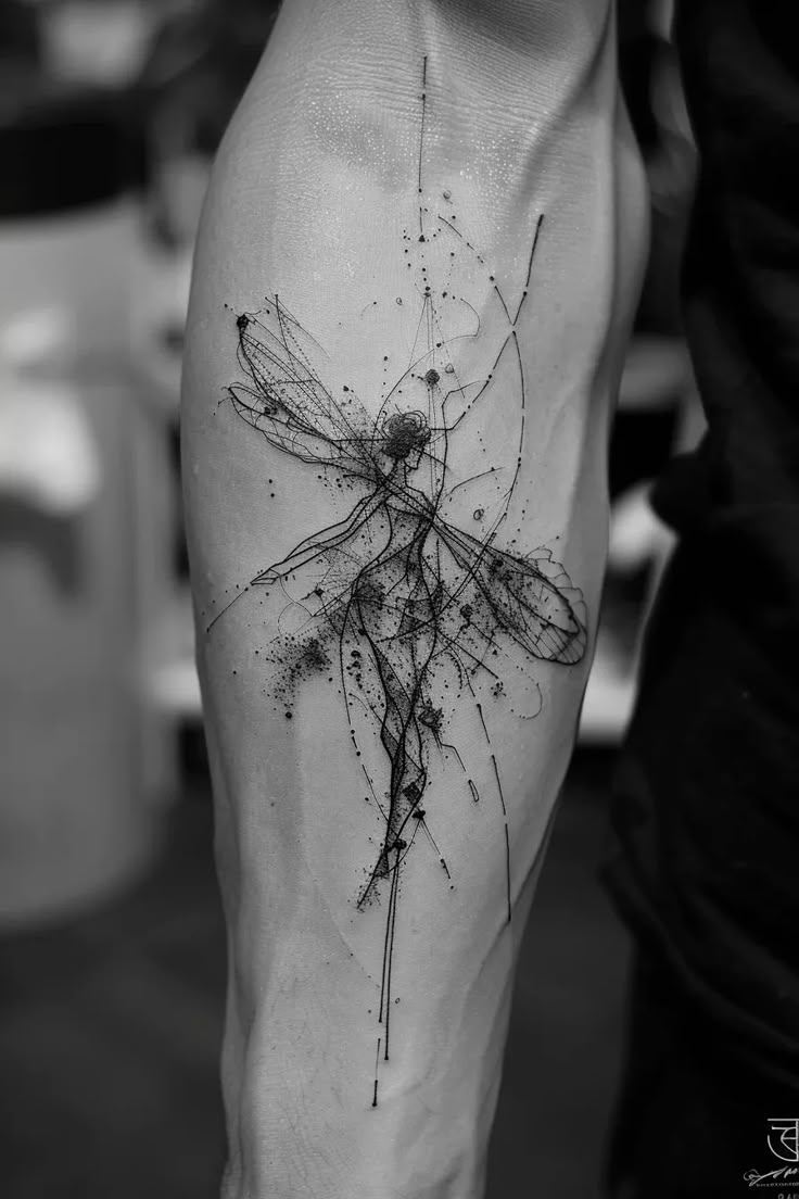 a black and white photo of a person's leg with a dragon tattoo on it