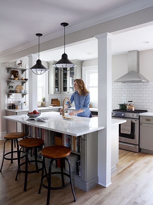 a woman is standing at the kitchen island