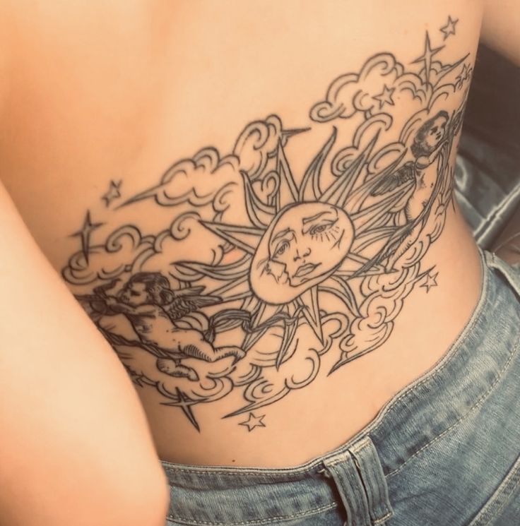 a woman with a sun and clouds tattoo on her stomach