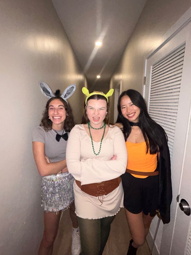 three women in bunny ears are posing for the camera