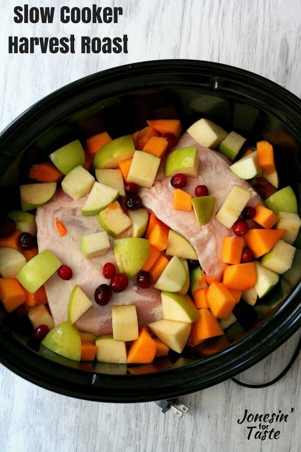 a slow cooker filled with fruit and meat